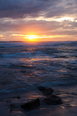 Fototapeta na wymiar Sea scape waves sunset light glow and cloudy sky