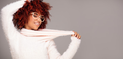 Happy woman with afro hairstyle smiling.