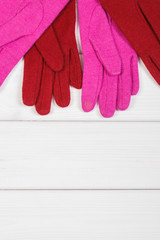 Colorful womanly gloves on boards, clothing for autumn or winter, copy space for text