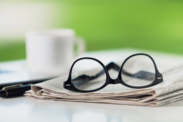 Glasses on newspaper.