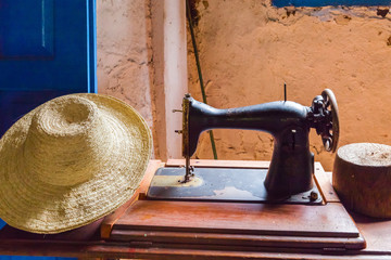 old sewing machine and straw hat