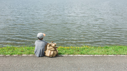 young asian boy traveling alone at nature park, vintage tone