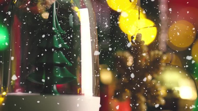 Greeting Season concept.Macro with Dolly of ornaments on a Christmas tree with decorative light and falling snow in 4k (UHD)