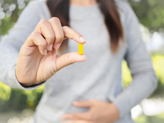 Close up of woman hand holding pills. Health care and medical concept.