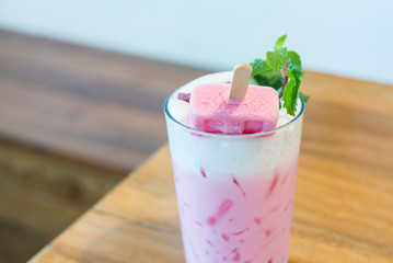 strawberry popsicle with pink milk in glass