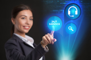 Young businesswoman working in virtual glasses, select the icon 24/7 service on the virtual display.