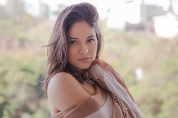 Naklejka premium Beautiful woman face close up portrait young, looking at camera in exterior.