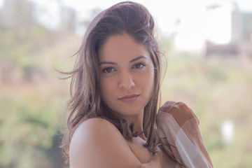 Beautiful woman face close up portrait young, looking at camera in exterior.