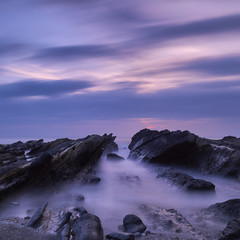 Fototapeta premium Long exposure of the sunset sky over sea rocks in Jogashima, Miura Peninsula, Japan