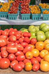 fresh picked tomatoes on table outside at farmers market