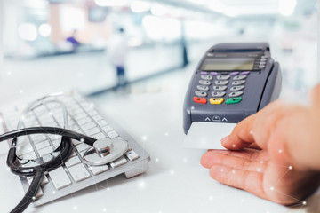 blurred image of counter services in hospitals and  paying with a credit card and using a terminal concept.