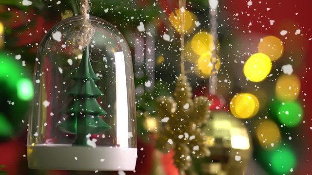 Greeting Season concept.Macro with Dolly of ornaments on a Christmas tree with decorative light and falling snow in 4k (UHD)