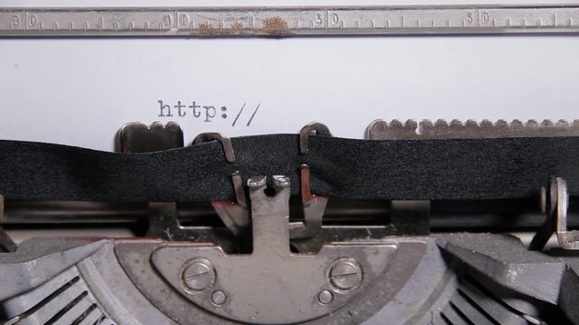 Typing the word - http - on a sheet of paper with an old vintage typewriter.

