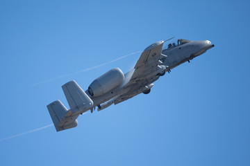A-10 Thunderbolt II in a very fast pass, with condensation trails at the wing edges and root