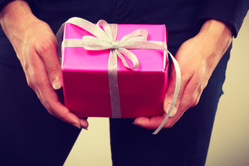 pink gift box in male hands