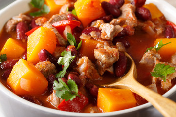 Chili pumpkin with beef and vegetables in tomato sauce macro. horizontal
