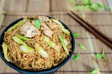 Fried noodle with pork appetizing placed on the dining table.