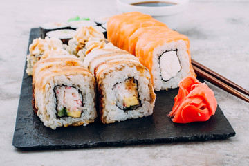 Delicious Assorted Sushi Set Sushi Maki - Eel Maki and Philadelphia Roll Sushi, Roll with avocado and hot fried rolls, ginger, wasabi, soy sauce. Copy Space for text.  Asian or Japanese food concept
