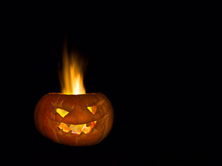 Scary head made of pumpkin. A real fire. Holiday Halloween.