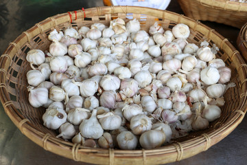 Fresh garlic in a bamboo basket at Bang Phra market, Chonburi, Thailand