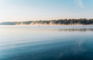 Fototapeta premium Morning clubs of autumn fog over the river