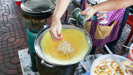 Local seller make Vietnamese crepe, Khanom Bueang Yaun at Talad Phu market, Bangkok, Thailand