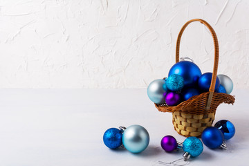 Christmas background with blue ornaments in wicker basket