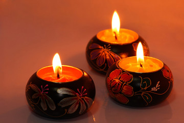 Three burning candles form a bottom border