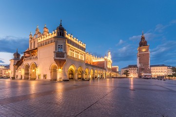 Fototapeta na wymiar Cloth Hall and Town Hall tower on the Main Market Square in Krakow, illuminated in the morning