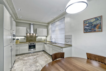 Modern design white kitchen in a spacious apartment.