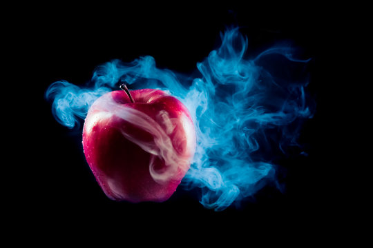 poisoned apple with dramatic lighhting on a black background