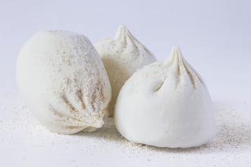 three frozen large raw khinkali