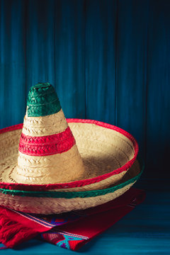 High contrast image of mexican hats and a serape on a wooden background