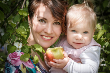 Fototapeta na wymiar Mother and daughter with apple in the hand