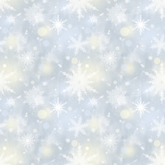 Fototapeta na wymiar Seamless Christmas pattern. White blurred snowflakes on a blue background.