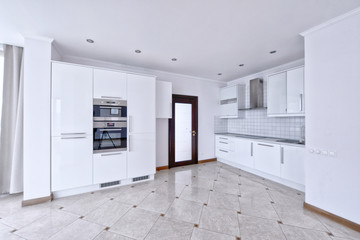 Modern design white kitchen in a spacious apartment.