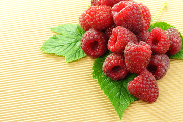 Raspberry on ribbed beige textured surface