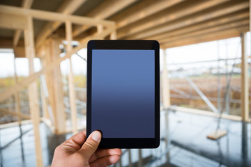 Hand Holding Digital Tablet With Blank Screen At Site