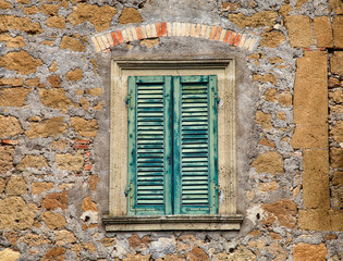 Old wooden window with green shutters