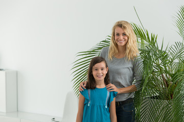 nanny and young girl in nice appartment