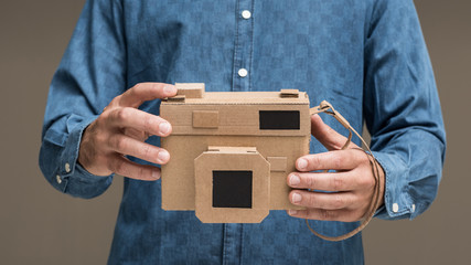 Photographer holding a cardboard camera