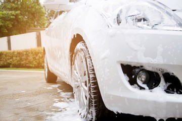 Outdoor car wash with foam soap.