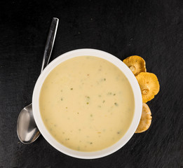 Creamy Chanterelle Soup on a vintage slate slab, selective focus