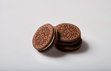 Chocolate cookies with cream filling on a light background in the studio