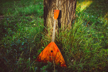 Folk musical instrument balalaika on wooden background