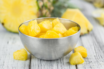 Portion of Pineapple (sliced) on wooden background, selective focus