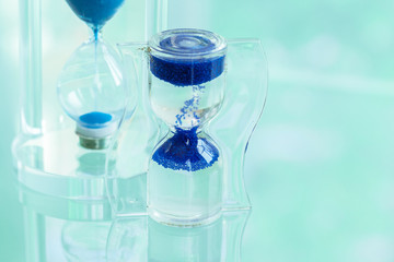 Time passing. Blue hourglass.