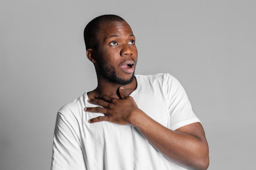 young attractive afro american man desperate in shock with opened mouth worried