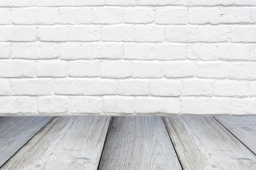 Gray wooden surface shelf or table and white brick wall