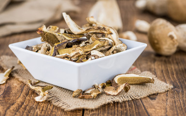 Dried Porcinis on vintage wooden background